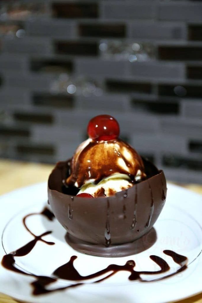 Easy Summer Recipes Roundup: Beat The Heat 16 Simple Recipes 19 Two scoops of ice cream inside a homemade chocolate bowl, topped with chocolate sauce and a maraschino cherry.