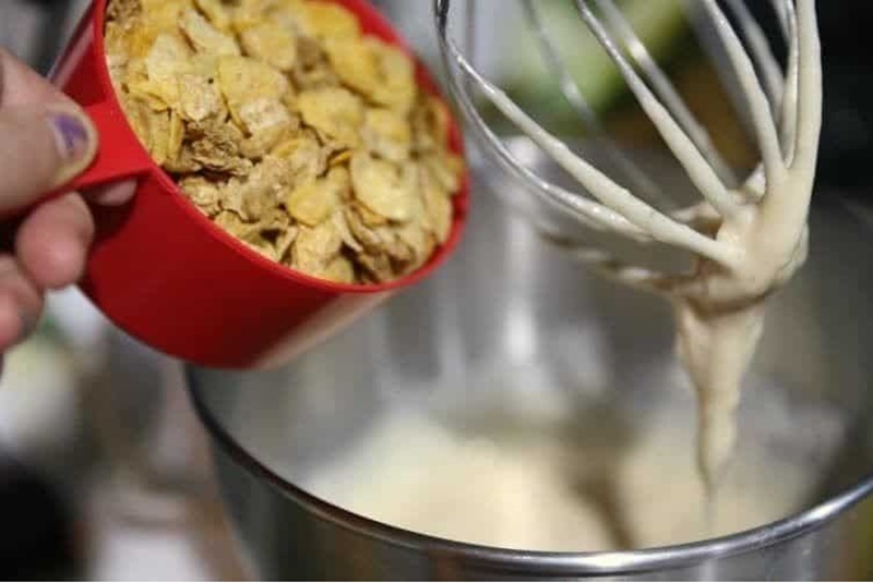 Honey Bunches of Oats Cinnamon Strudel Muffins 12 pouring cereal into cake batter