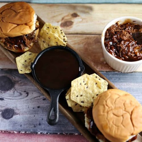 Zesty Slow Cooker Barbeque Chicken Sandwiches 16 bbq sandwiches on plate with bbq sauce and chips