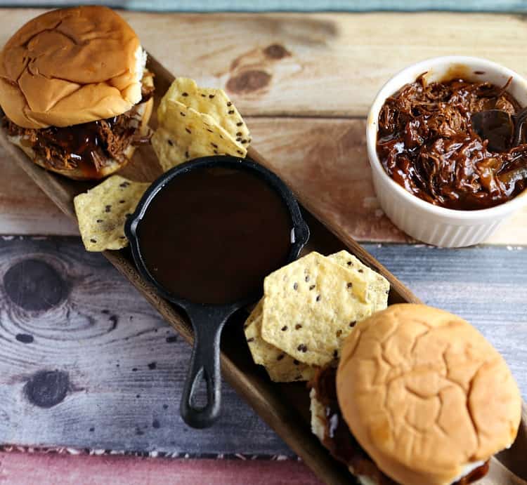 Zesty Slow Cooker Barbeque Chicken Sandwiches 12 bbq sandwiches on plate with bbq sauce and chips