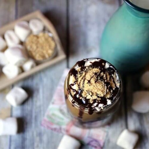 S'more's Iced Coffee in mason jar sitting on courter with marshmallows