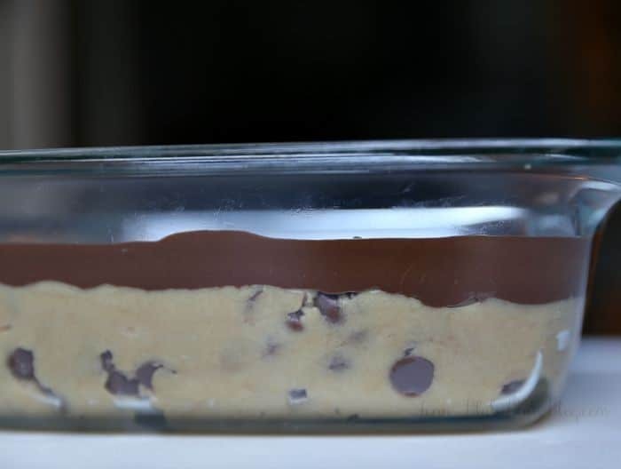 cookie dough bars with chocolate layer in glass dish