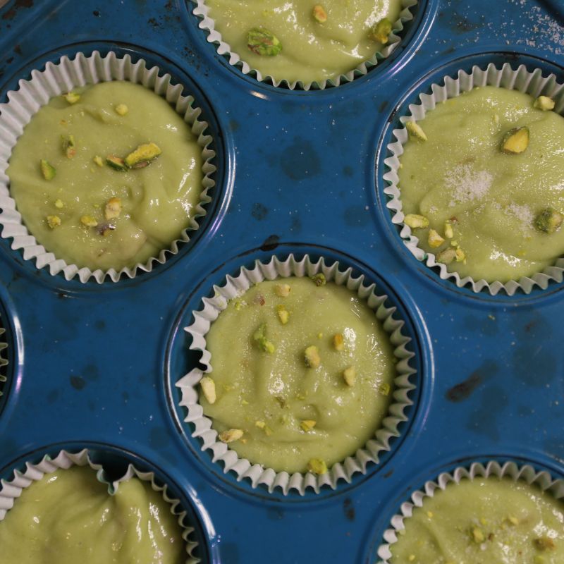pistachio muffin batter in cupcake pan
