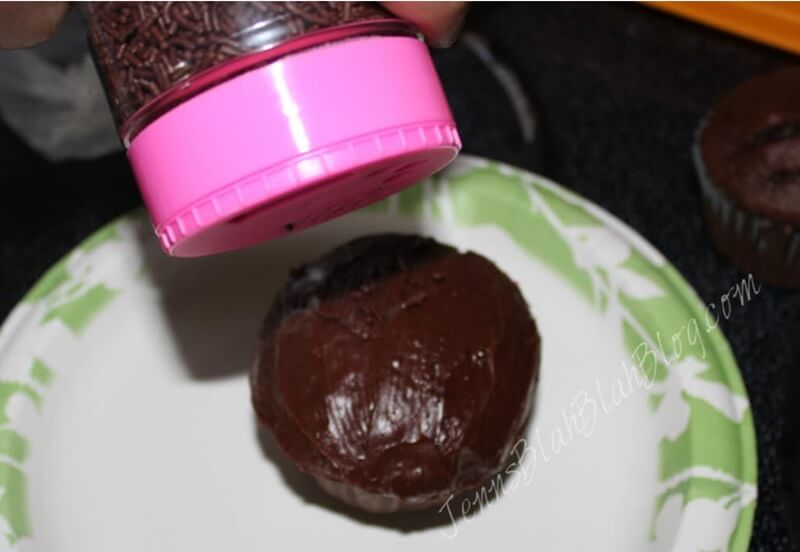 Halloween Black Cat Chocolate Cupcakes 17 putting sprinkles on chocolate cupcake