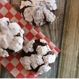 Brownie Crinkle Cookies sitting on red and white checker napkin | Half Baked Media